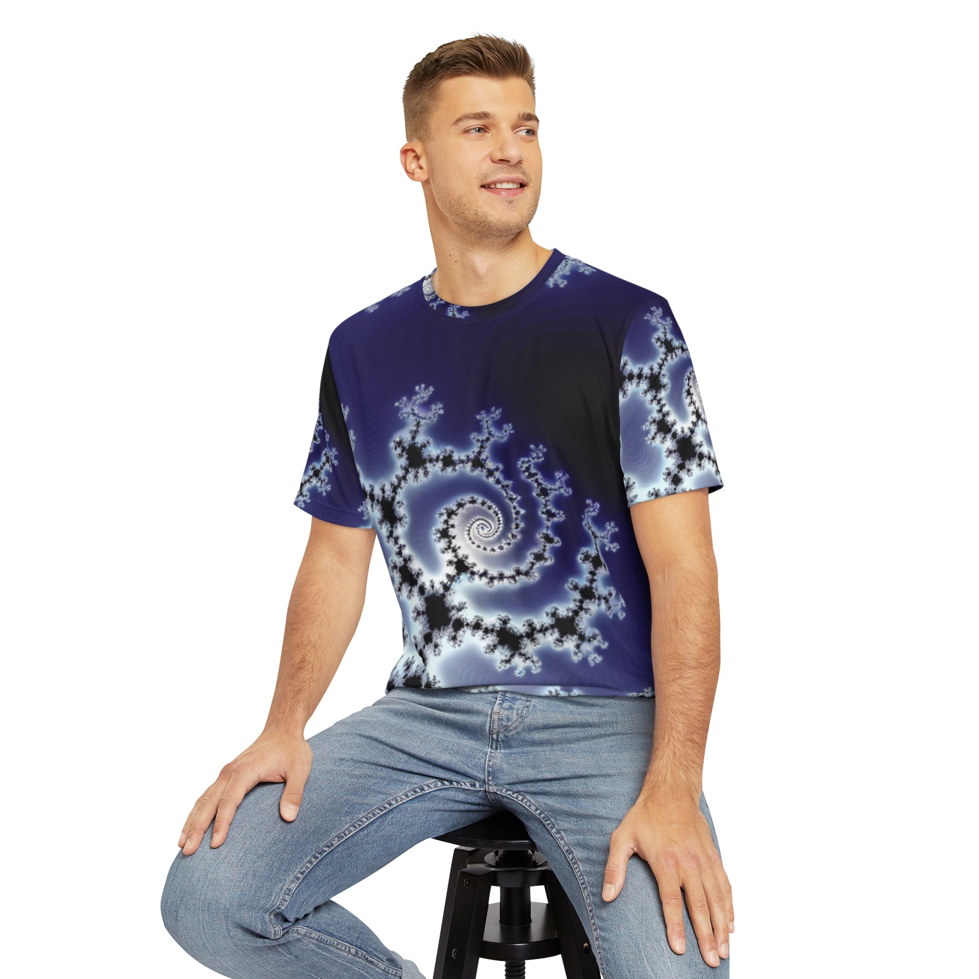 Front view of the Celestial Fractal Elegance Crewneck Pullover All-Over Print Short-Sleeved Shirt purple black white fractal pattern paired with casual denim pants worn by a white man sitting on a stool chair