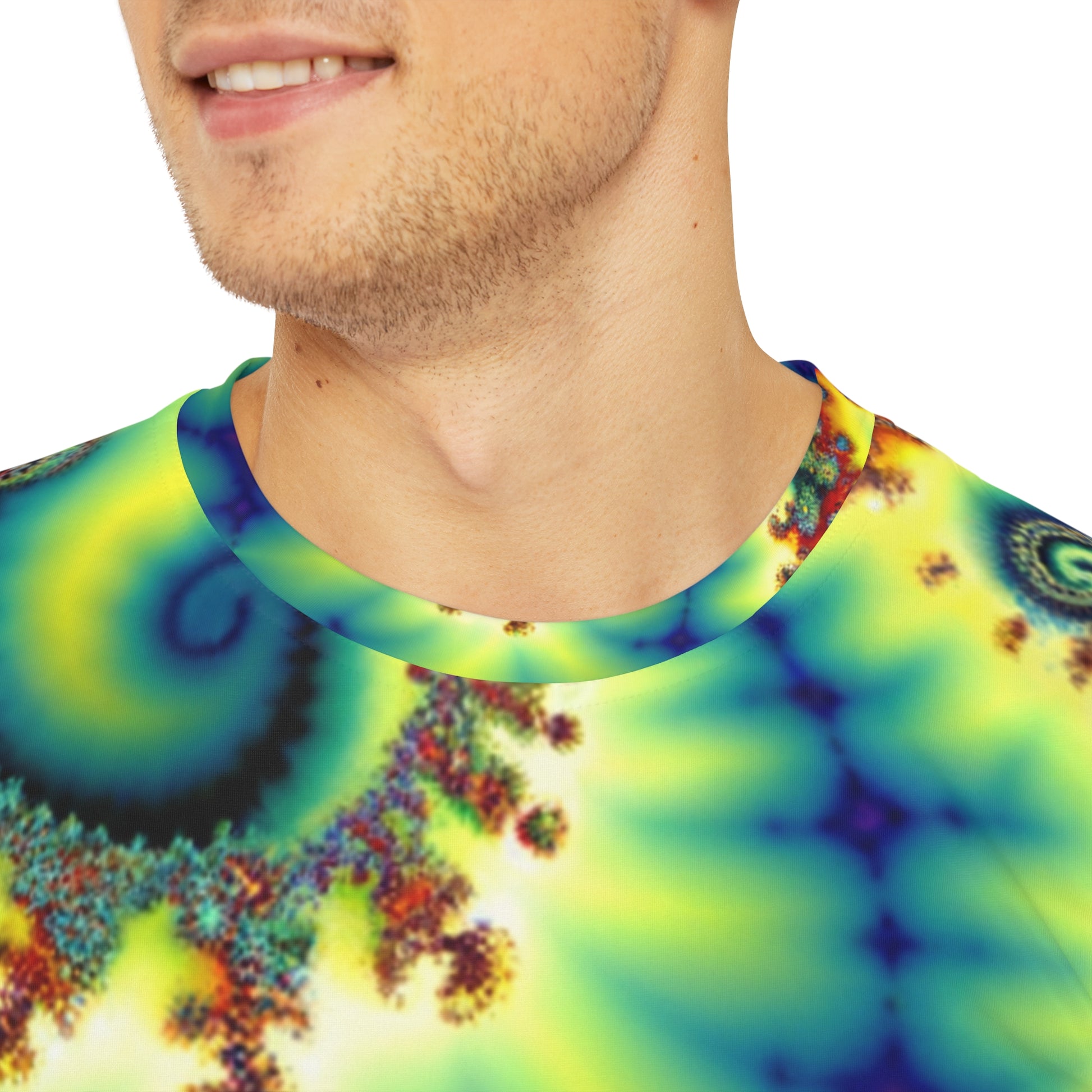 Close-up shot of the Spectral Helix Dreamatorium Crewneck Pullover All-Over Print Short-Sleeved Shirt yellow oranger red blue green purple spectral pattern worn  by a white man