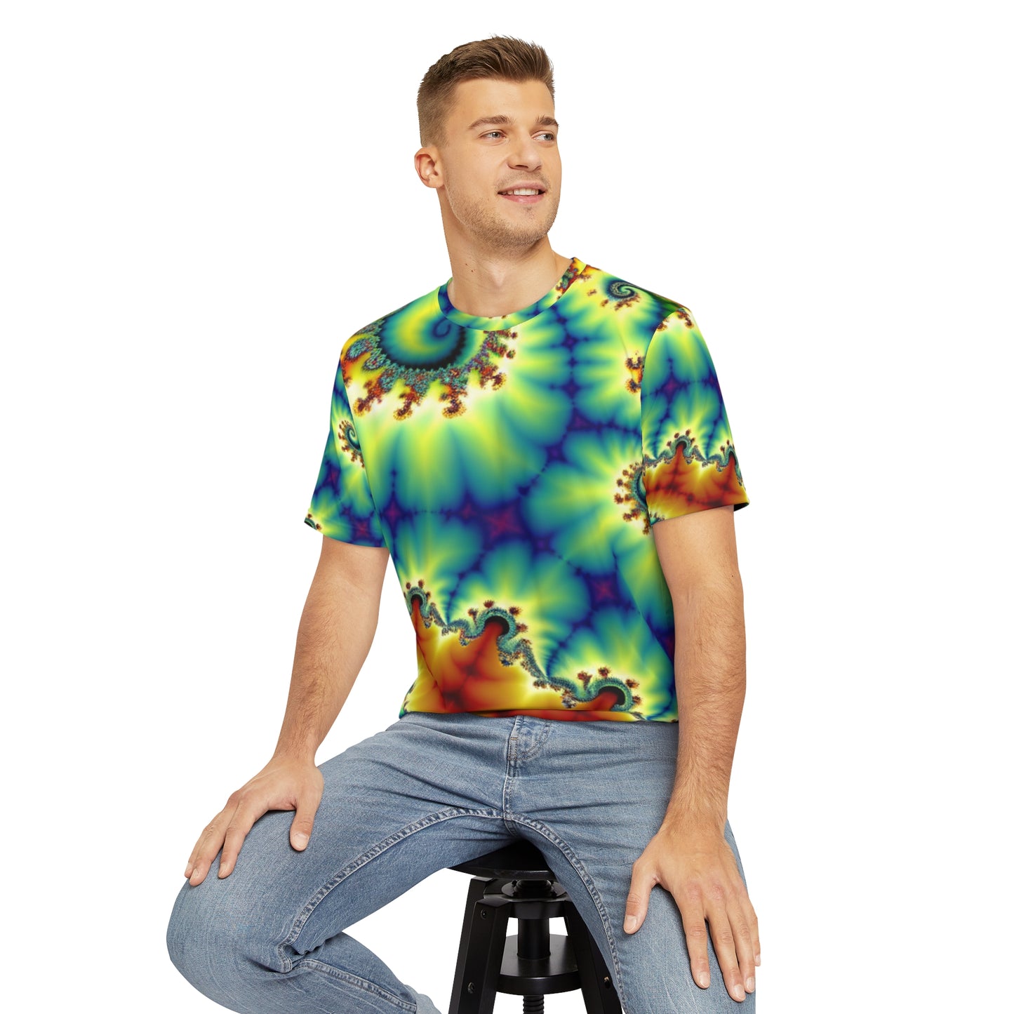 Front view of the Spectral Helix Dreamatorium Crewneck Pullover All-Over Print Short-Sleeved Shirt yellow oranger red blue green purple spectral pattern paired with casual denim pants worn  by a white man sitting on a stool chair