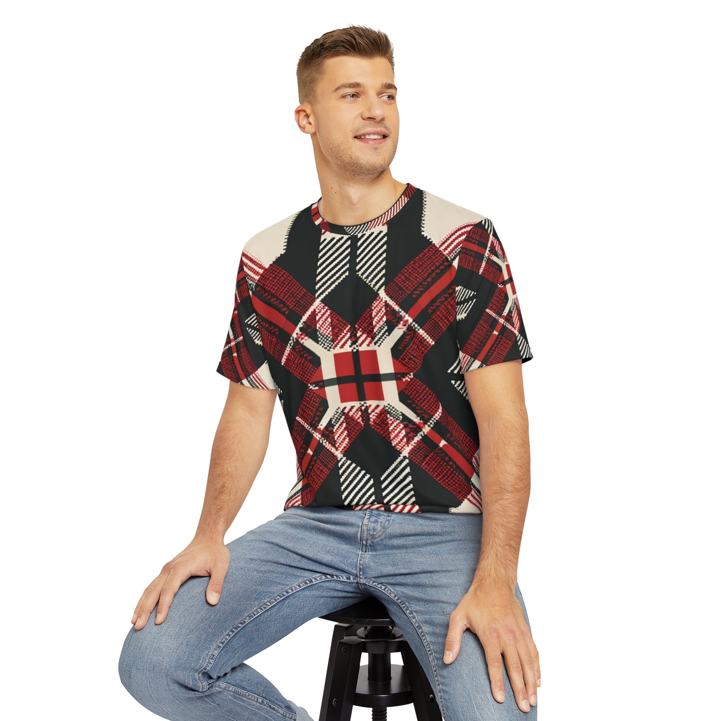 Front view of the Highland Matrix Tartan Crewneck Pullover All-Over Print Short-Sleeved Shirt red black beige plaid print paired with casual denim pants worn by a white man sitting on a stool chair