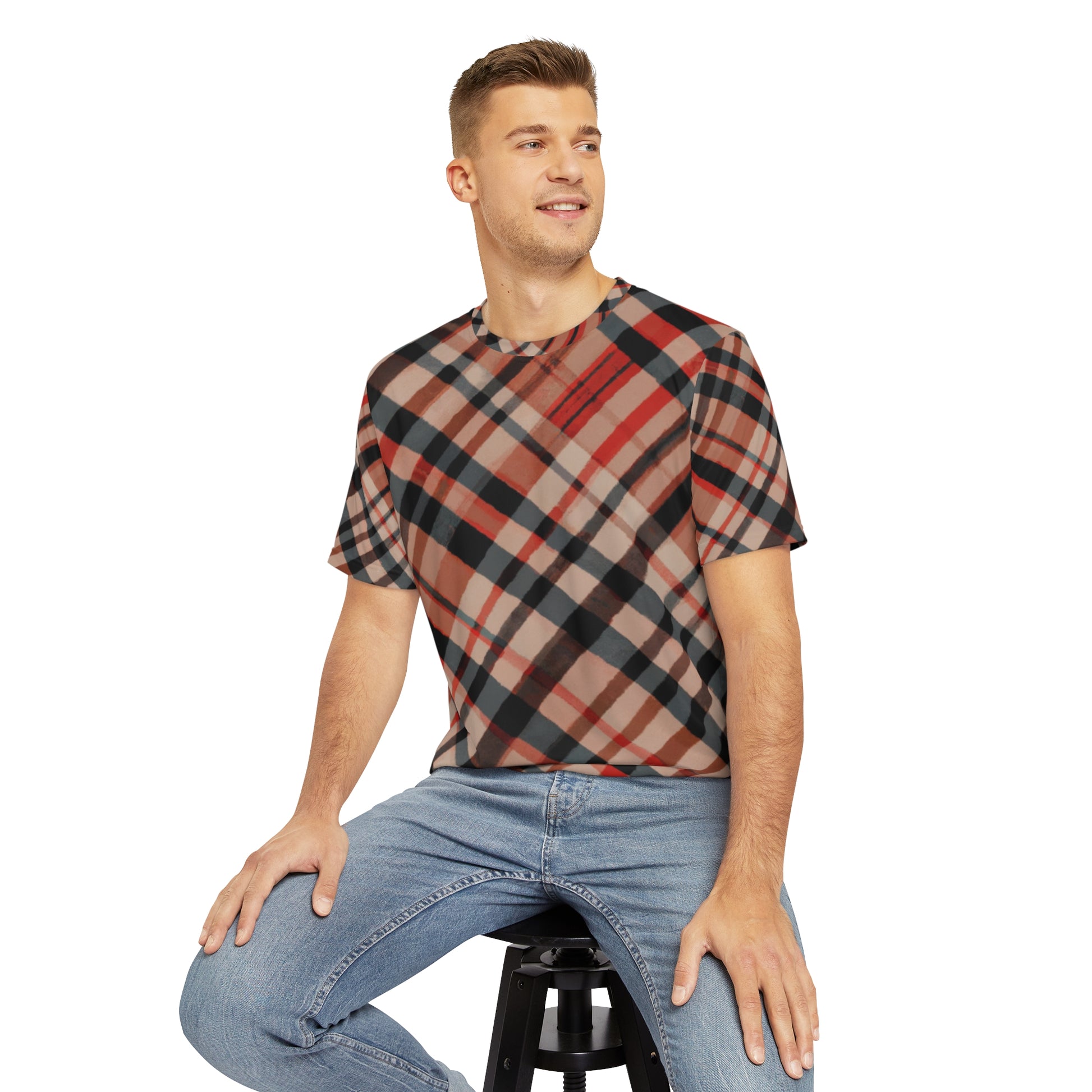 Front view Highland Ember Clash Crewneck Pullover All-Over Print Short-Sleeved Shirt red black beige brown plaid pattern paired with casual denim pants worn by a white man sitting on a stool chair