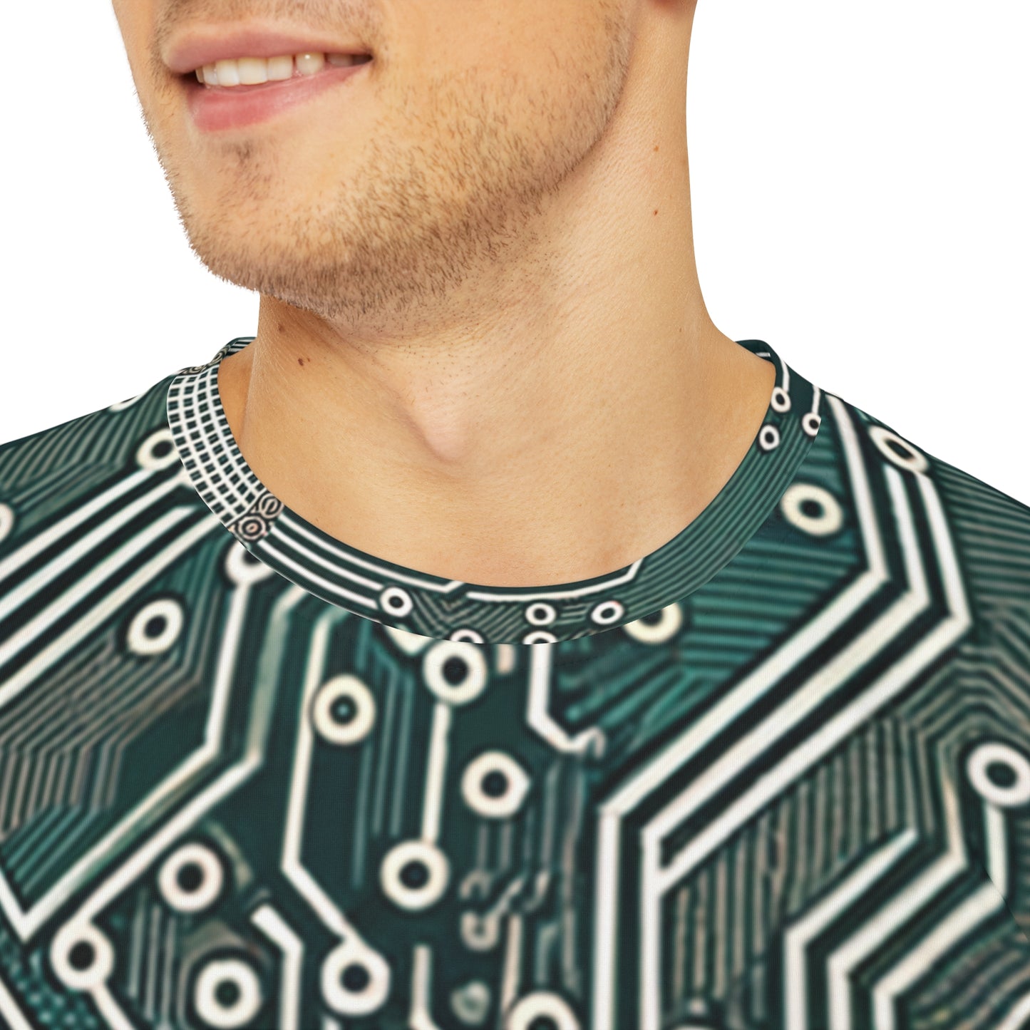 Close-up shot of the Circuit Symmetry Matrix Crewneck Pullover All-Over Print Short-Sleeved Shirt green gray black beige circuit pattern worn by a white man sitting on a stool chair 