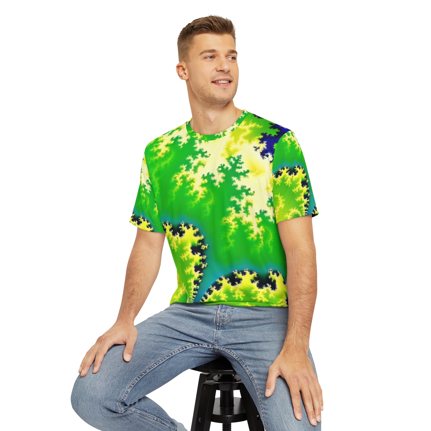 Front view of the Psychedelic Serpentine Fractal Fusion Crewneck Pullover All-Over Print Short-Sleeved Shirt green yellow blue black psychedelic pattern paired with casual denim pants worn by a white man sitting on a stool chair